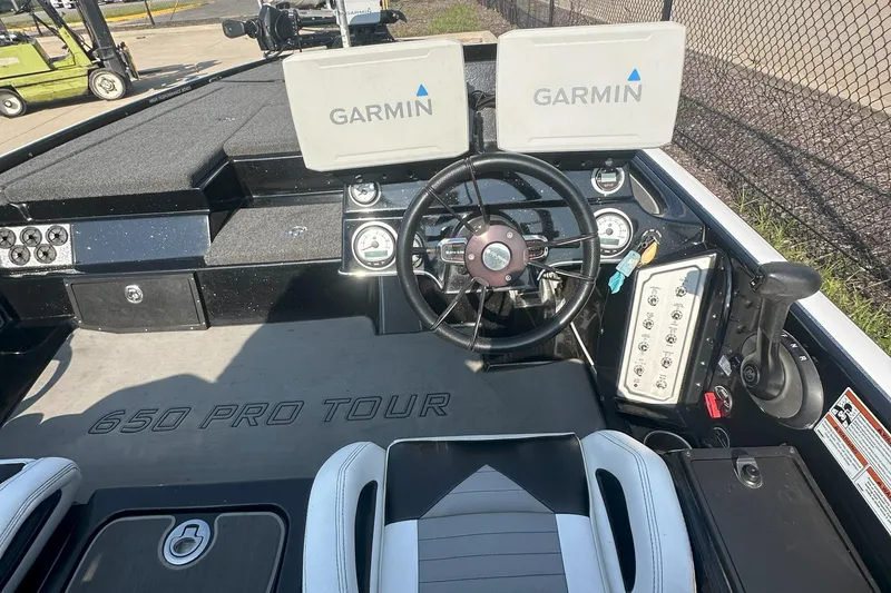 Slide: The Image of 2021 Blazer 650 Pro Tour boat dashboard with Garmin displays and steering wheel. - 16