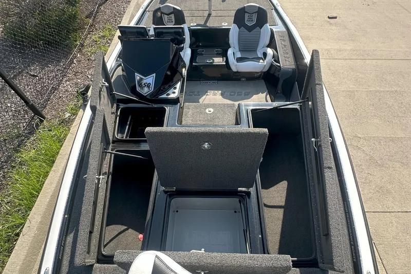 Slide: The Image of 2021 Blazer 650 Pro Tour boat interior with open storage compartments and seating. - 17