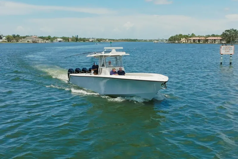 Slide: The Image of 2021 SeaVee 390Z boat cruising on a sunny day in a calm waterway. - 11