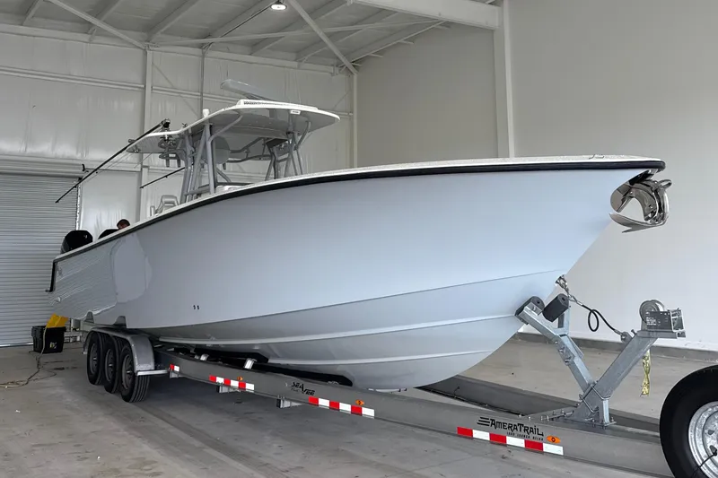 Slide: The Image of 2021 SeaVee 390Z boat cruising on open water with four powerful engines. - 2