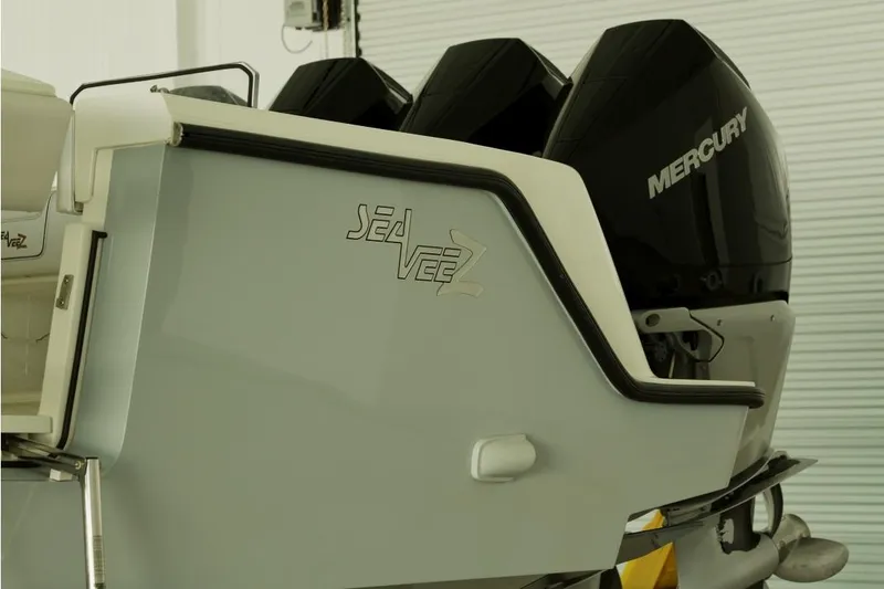 Slide: The Image of 2021 SeaVee 390Z boat with Mercury engines, rear view in a garage setting. - 6