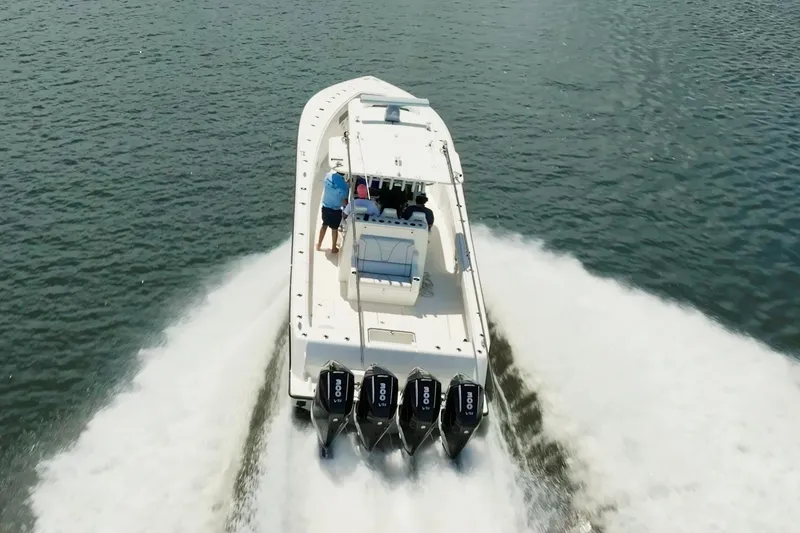 Slide: The Image of 2021 SeaVee 390Z boat cruising on water with four powerful engines. - 7