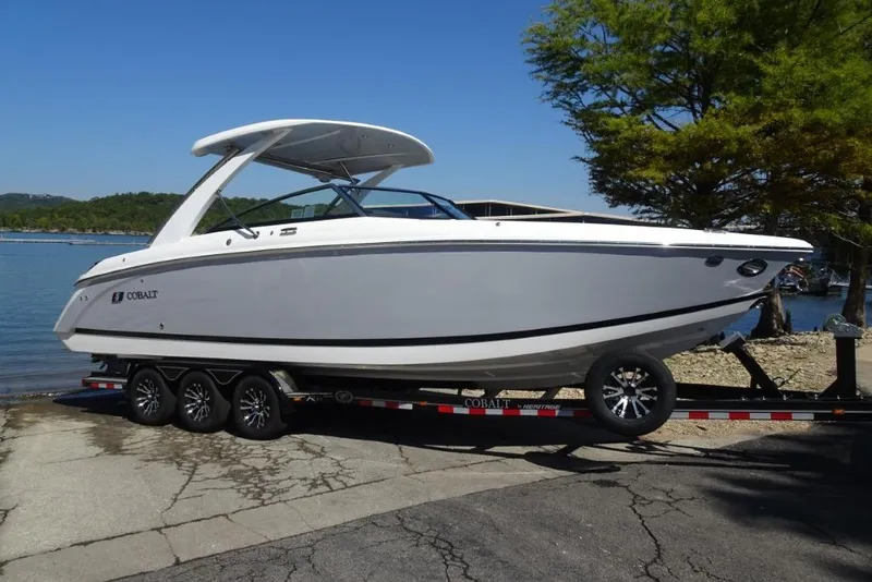 The Image of 2025 Cobalt R30 boat on trailer by a lake, ready for launch. - 0