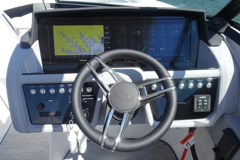 Slide: The Image of 2025 Cobalt R30 boat dashboard with steering wheel and navigation screens. - 13