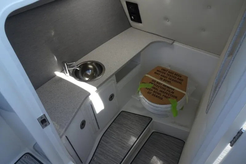 Slide: The Image of Interior of 2025 Cobalt R30 boat featuring compact sink and toilet area. - 16
