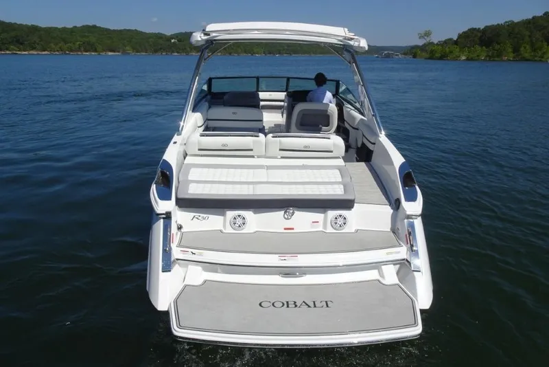 Slide: The Image of 2025 Cobalt R30 boat on a lake, featuring spacious seating and sleek design. - 7