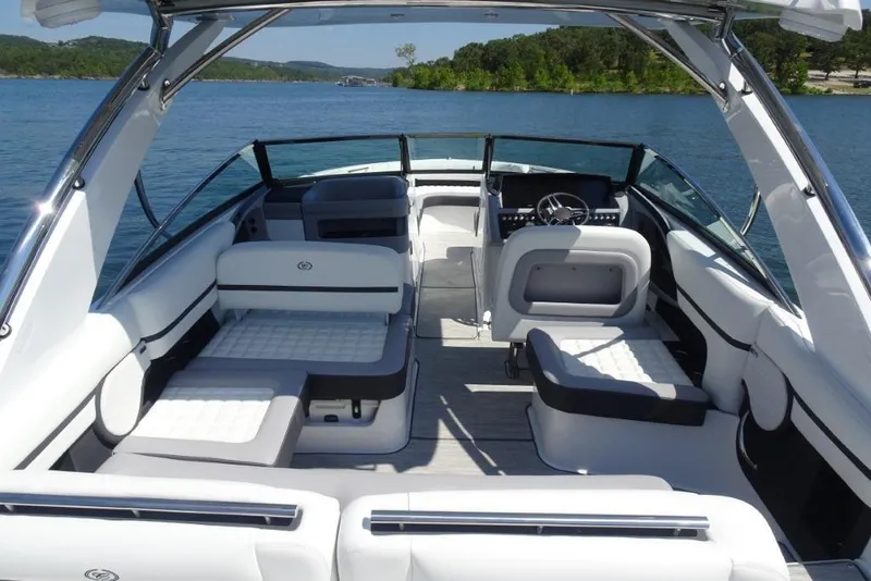 Slide: The Image of 2025 Cobalt R30 boat interior with luxurious seating on a serene lake. - 9