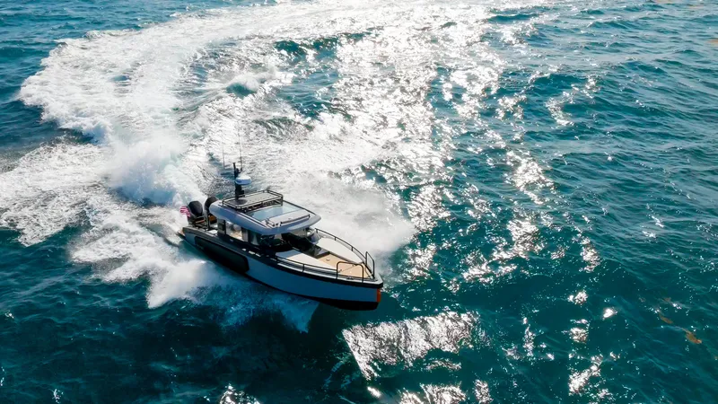 Slide: The Image of 2023 Arksen 30 boat cruising on open ocean, creating dynamic water trails. - 14