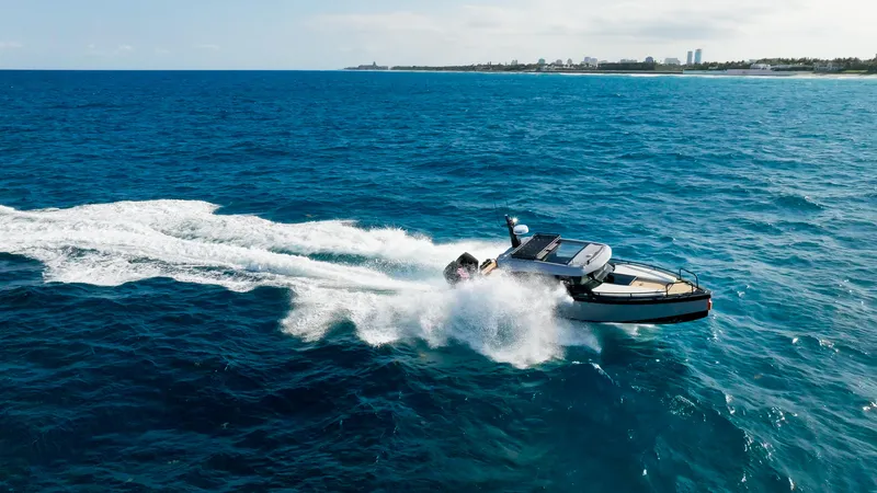 Slide: The Image of 2023 Arksen 30 boat cruising on open blue ocean near coastline. - 15