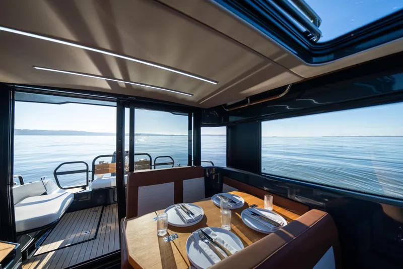 Slide: The Image of Interior of 2023 Arksen 30 yacht with dining table, overlooking serene ocean view. - 35