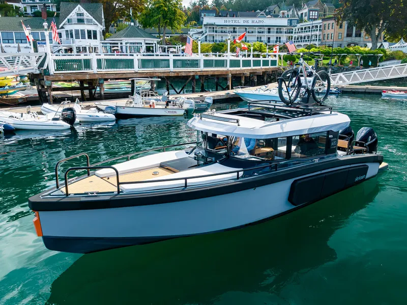 Slide: The Image of 2023 Arksen 30 boat docked with bicycles on roof, scenic waterfront background. - 4