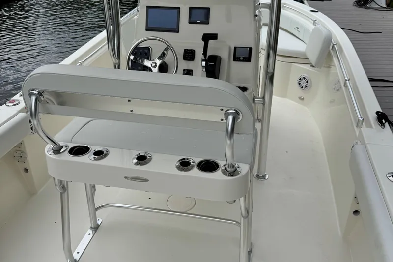 Slide: The Image of 2026 Cobia 220 Center Console boat interior with steering wheel and seating. - 10