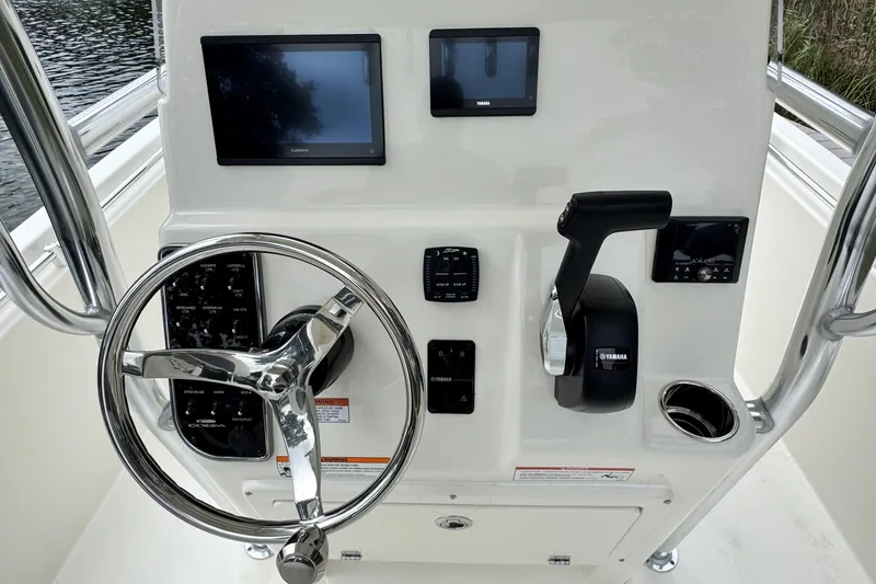 Slide: The Image of 2026 Cobia 220 Center Console dashboard with steering wheel and electronic controls. - 12
