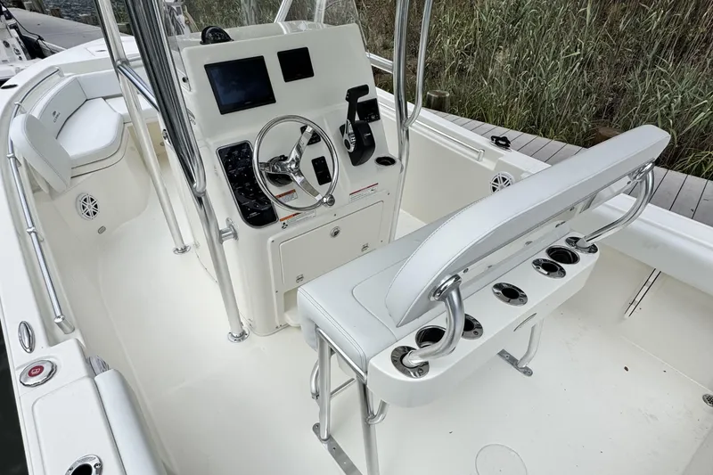 Slide: The Image of 2026 Cobia 220 Center Console boat interior with steering wheel and seating. - 9