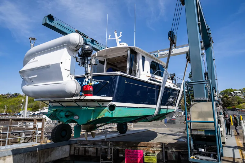 Slide: The Image of 2013 Back Cove 37 boat being lifted at a marina. - 10