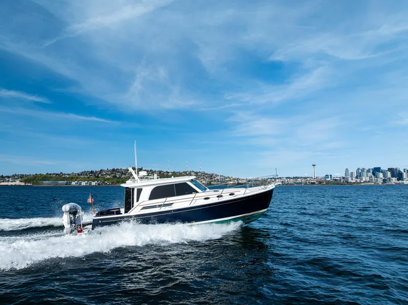 Slide: The Image of 2013 Back Cove 37 cruising on open water under a clear blue sky. - 14