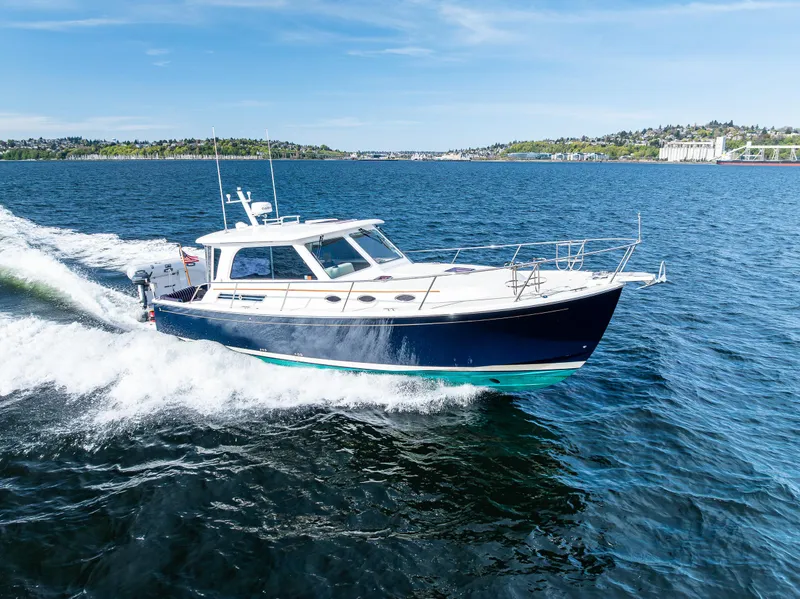 Slide: The Image of 2013 Back Cove 37 cruising on open water under clear blue skies. - 16