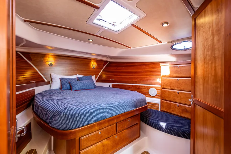 Slide: The Image of Luxurious cabin interior of 2013 Back Cove 37 yacht with wood finish and cozy bedding. - 22