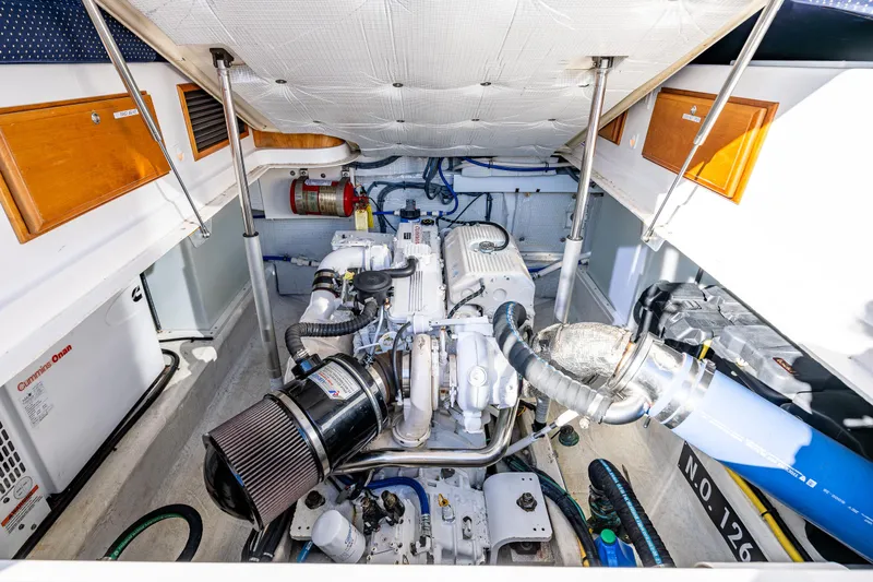 Slide: The Image of Engine compartment of a 2013 Back Cove 37 boat, showcasing detailed mechanical components. - 36