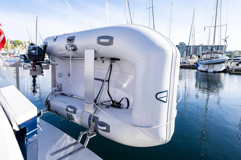Slide: The Image of Inflatable boat mounted on a 2013 Back Cove 37 yacht at a marina. - 40