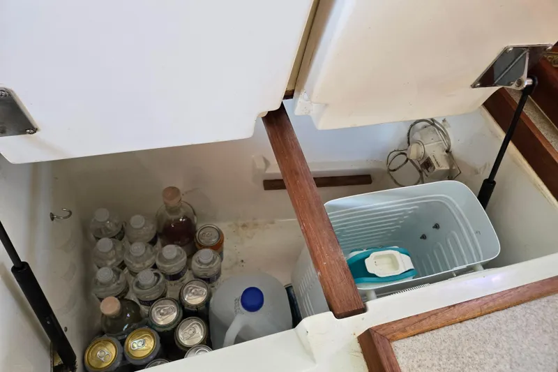 Slide: The Image of Storage compartment in a 1992 Hunter 35.5 boat, containing drinks and a cooler. - 12