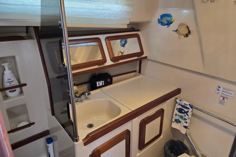 Slide: The Image of Interior of 1992 Hunter 35.5 sailboat bathroom with sink, mirrors, and marine decor. - 15