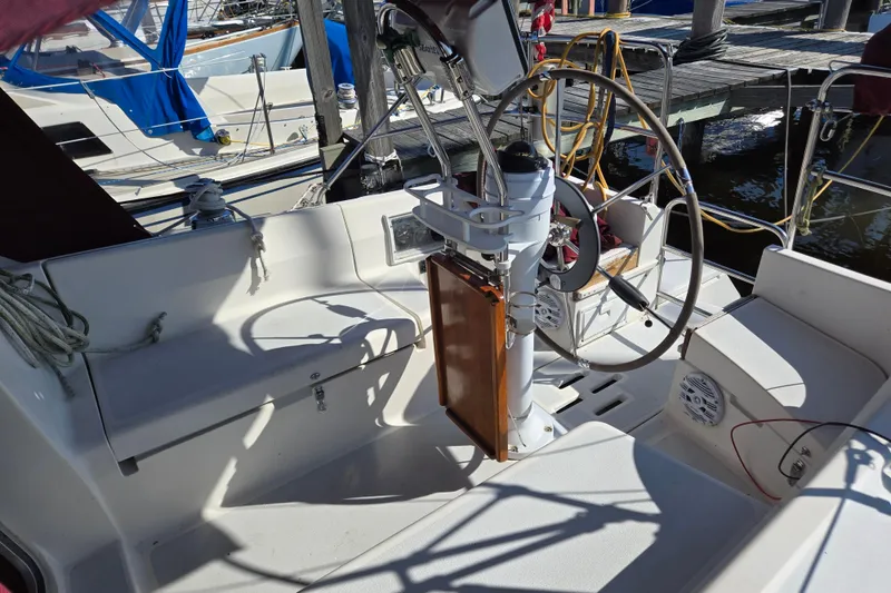 Slide: The Image of Cockpit of a 1992 Hunter 35.5 sailboat with steering wheel and docked surroundings. - 21