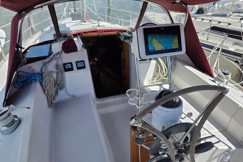 Slide: The Image of Cockpit of 1992 Hunter 35.5 sailboat with navigation equipment and steering wheel. - 27