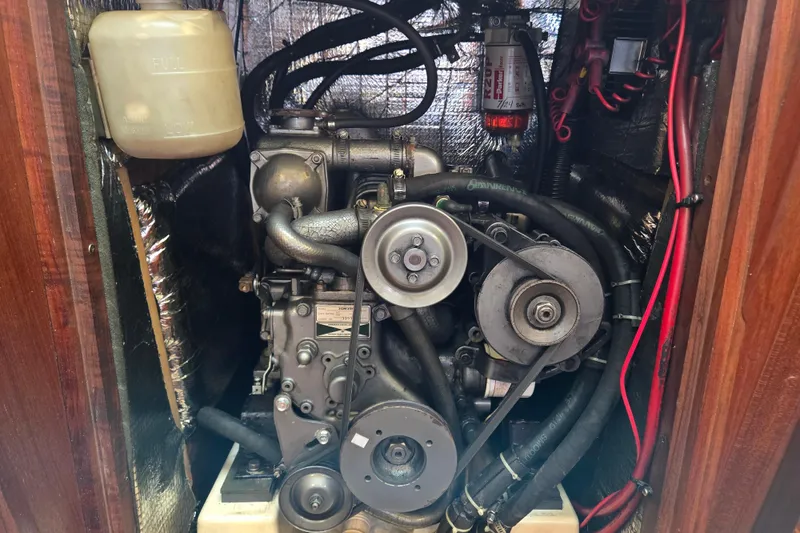 Slide: The Image of Engine compartment of a 1992 Hunter 35.5 sailboat, showing belts and hoses. - 29