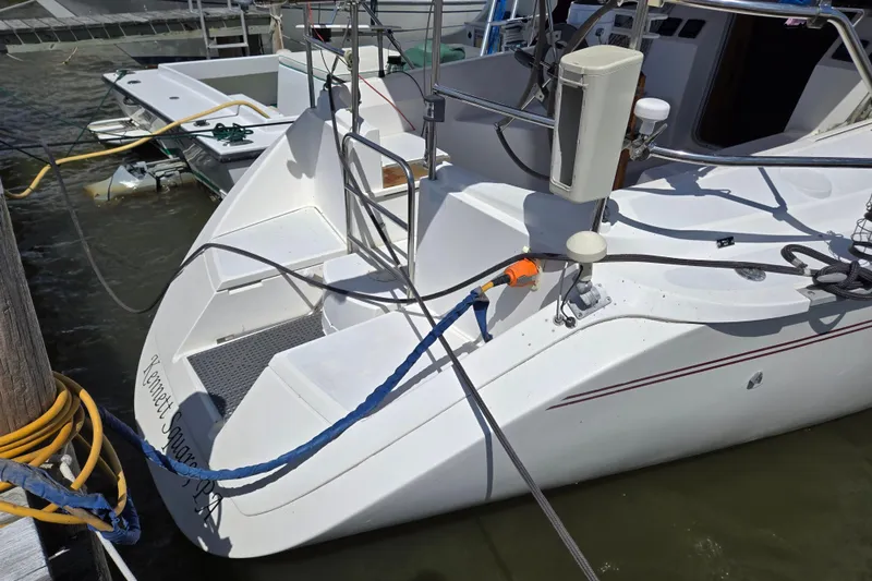 Slide: The Image of 1992 Hunter 35.5 sailboat docked, showing stern and deck details. - 34
