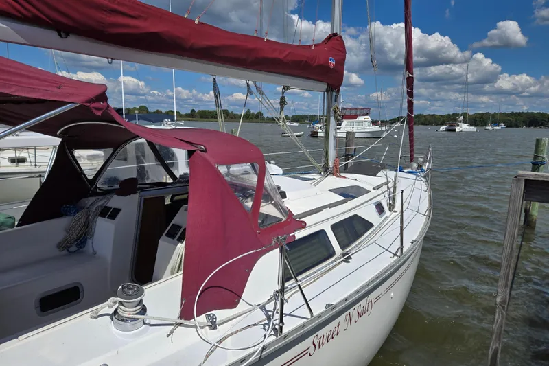 Slide: The Image of Sailboat "Sweet 'N Salty" docked, Hunter 35.5 model, 1992, with maroon canopy and sails. - 37