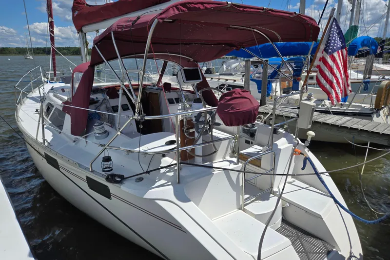 Slide: The Image of Sailboat docked at marina, 1992 Hunter 35.5 model with American flag. - 38