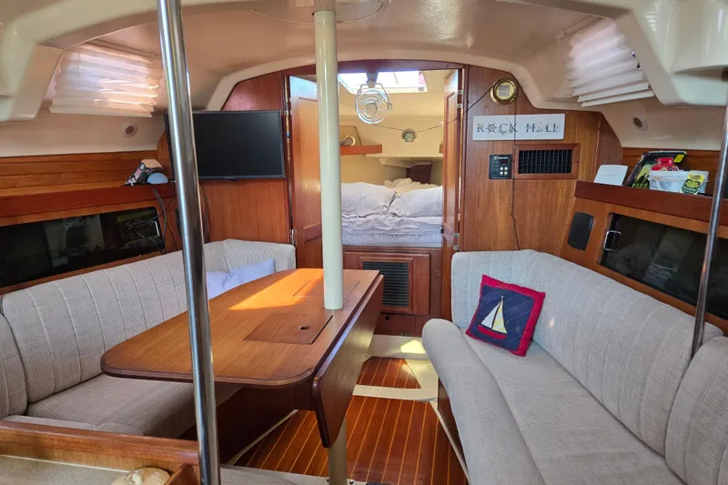 Slide: The Image of Interior of a 1992 Hunter 35.5 sailboat with cozy seating and wooden finishes. - 5
