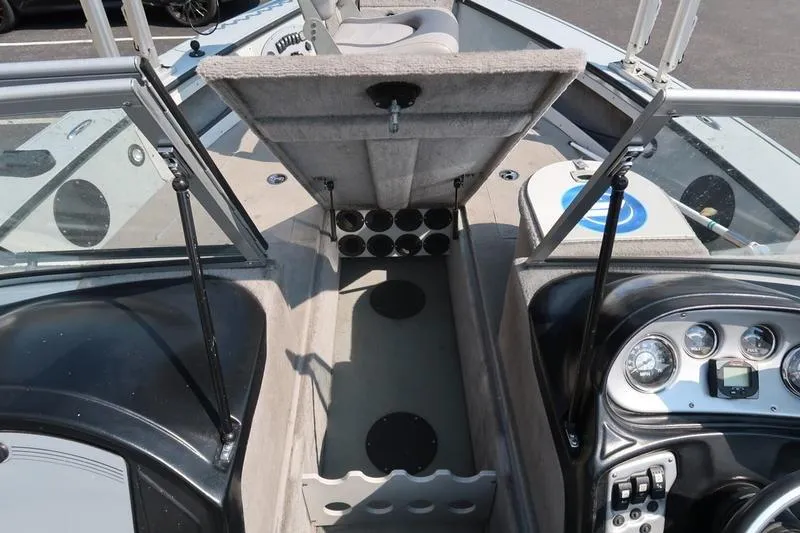 Slide: The Image of 2008 Starcraft STX PRO 2050 boat interior with open storage compartment and dashboard controls. - 13