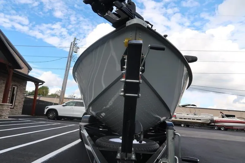 Slide: The Image of 2008 Starcraft STX PRO 2050 boat on trailer, parked in lot under blue sky. - 16