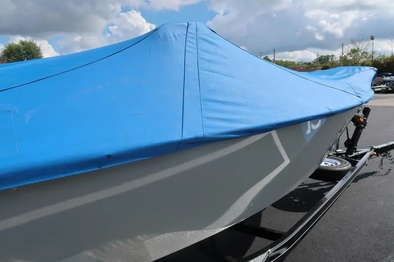 Slide: The Image of 2008 Starcraft STX PRO 2050 boat with blue cover on trailer. - 17
