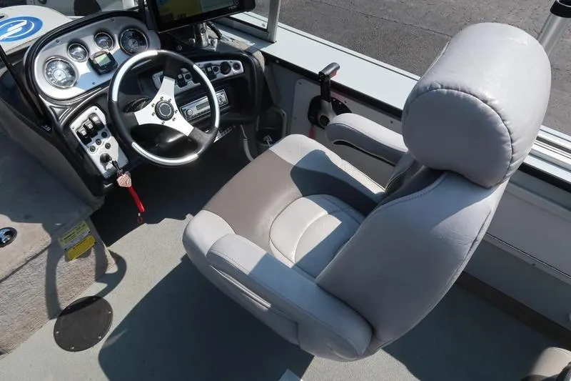 Slide: The Image of 2008 Starcraft STX PRO 2050 boat cockpit with steering wheel and captain's chair. - 20