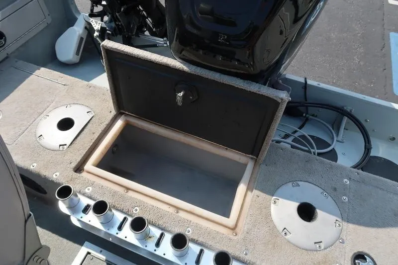 Slide: The Image of 2008 Starcraft STX PRO 2050 boat interior with open storage compartment and motor. - 29