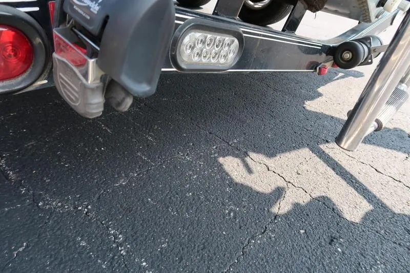Slide: The Image of Trailer hitch and lights of a 2008 Starcraft STX PRO 2050 on asphalt. - 31