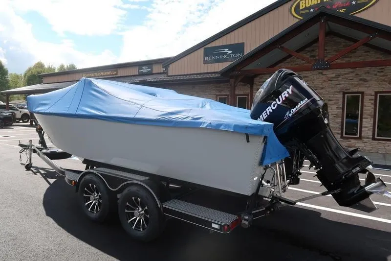 Slide: The Image of 2008 Starcraft STX PRO 2050 boat with blue cover on trailer, Mercury outboard engine. - 33