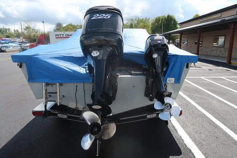 Slide: The Image of 2008 Starcraft STX PRO 2050 boat with dual outboard motors, covered in blue tarp. - 36
