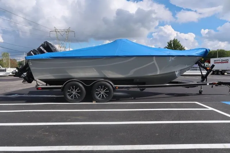 Slide: The Image of 2008 Starcraft STX PRO 2050 boat on trailer with blue cover, parked outdoors. - 37