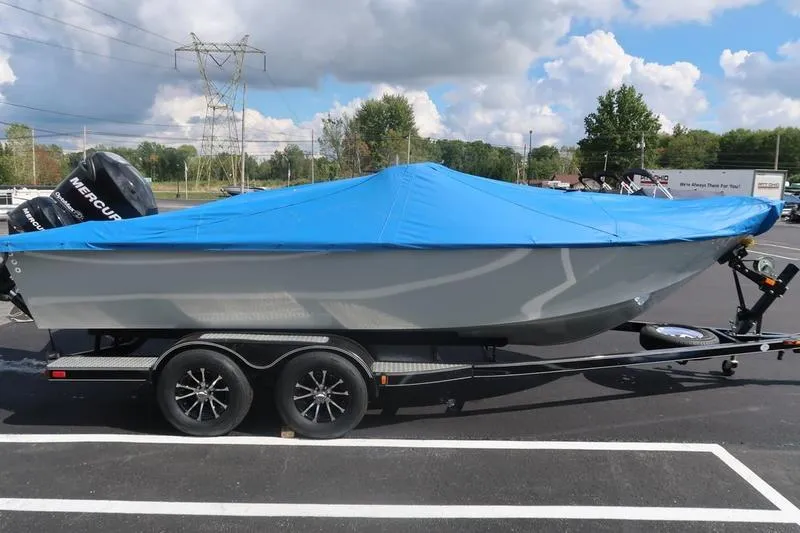 Slide: The Image of 2008 Starcraft STX PRO 2050 boat with blue cover on trailer in parking lot. - 42