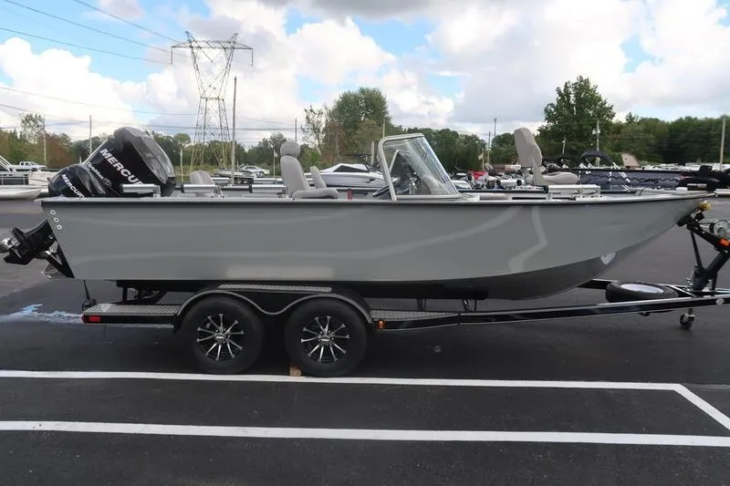 Slide: The Image of 2008 Starcraft STX PRO 2050 boat on trailer, parked outdoors under cloudy sky. - 5