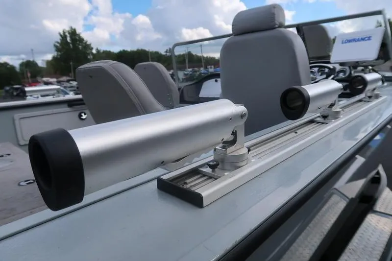 Slide: The Image of 2008 Starcraft STX PRO 2050 boat with rod holders and seating, under a cloudy sky. - 50