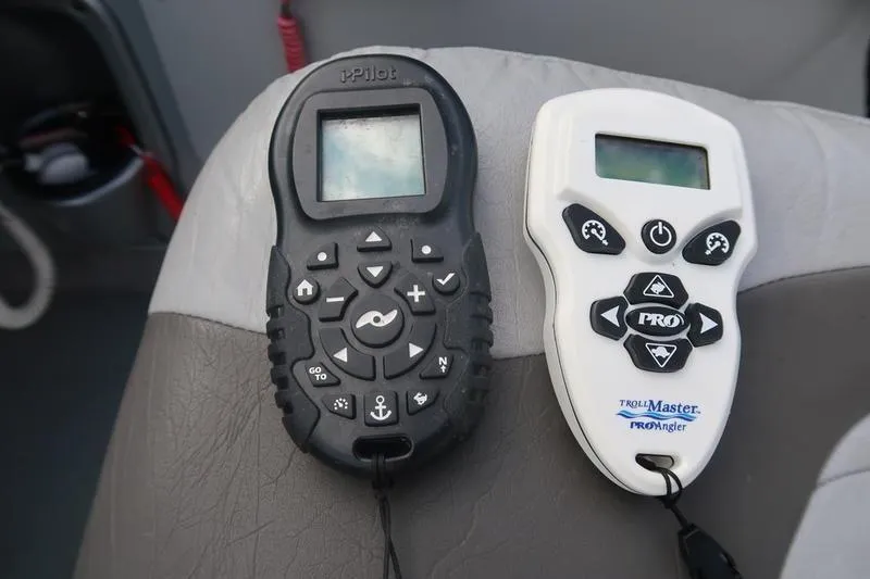 Slide: The Image of Two remote controls on a boat seat, Starcraft STX PRO 2050, 2008 model. - 53