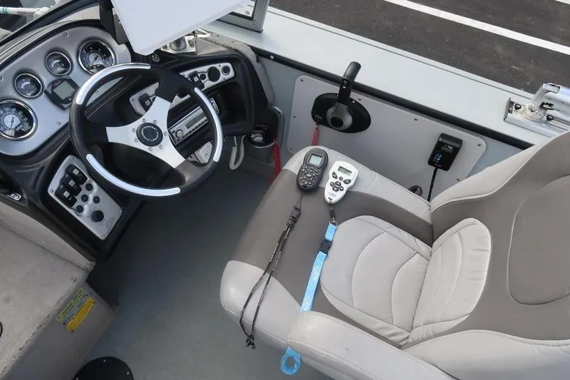 Slide: The Image of 2008 Starcraft STX PRO 2050 boat cockpit with steering wheel and control panel. - 59