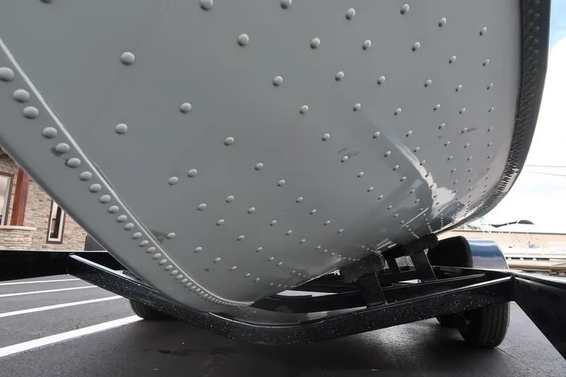 Slide: The Image of 2008 Starcraft STX PRO 2050 boat hull on trailer, showcasing riveted design. - 6