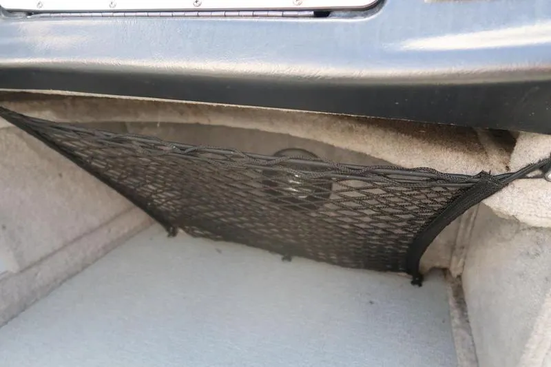 Slide: The Image of Storage compartment with netting in a 2008 Starcraft STX PRO 2050 boat. - 61