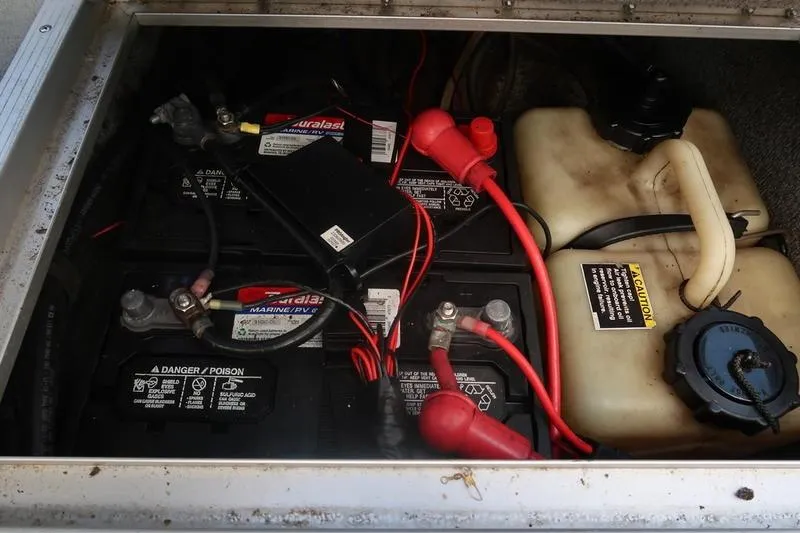 Slide: The Image of Battery compartment of a 2008 Starcraft STX PRO 2050 with wiring and fluid container. - 63
